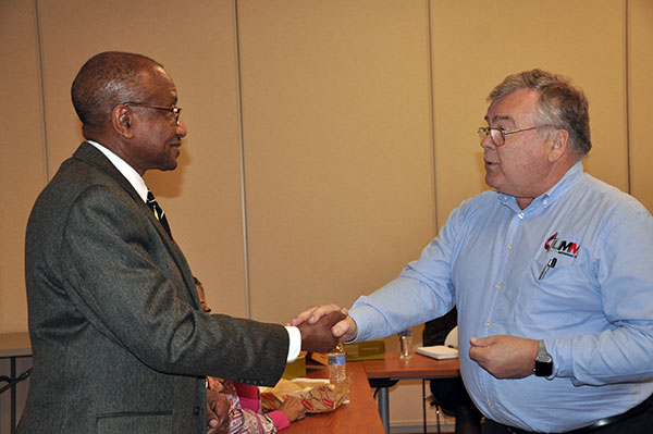 Bishop Marcus Matthews, left, receives a marble from Bill Weller.