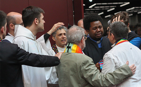 Activists support each other following a silent march through the May 18 plenary session of the 2016 United Methodist General Conference in Portland, Ore. They are protesting what they believe is an attempt to silence LGBTQ voices. Photo by Maile Bradfield, UMNS.